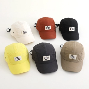 Flat lay of quick-dry outdoor hats in six colors with GO patch and D-ring detail