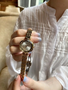 Detail of elegant gold stainless steel watch strap with secure fold-over clasp closure