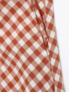 Close-up of orange and white gingham fabric featuring a high-quality invisible side zipper