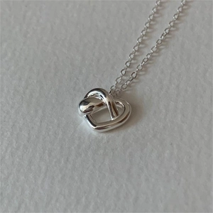 Minimalist S925 sterling silver heart knot pendant necklace with a polished finish