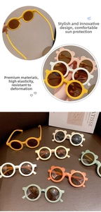 Detailed view of colorful round children's sunglasses with cute ear design on leather background