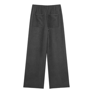 Detail of dark grey wide-leg pants featuring elastic waistband and rear patch pockets