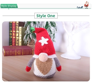 Close-up of a knitted Christmas gnome with a red star hat and small green metal bell