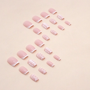 Elegant short coffin press-on nails featuring pink French tips and white leaf patterns
