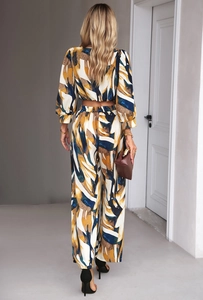 Detail view of the V-shaped back cut and abstract colorful print on a two-piece leisure set