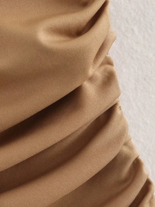 Macro shot of brown ruched knit fabric texture and high-quality pleated details