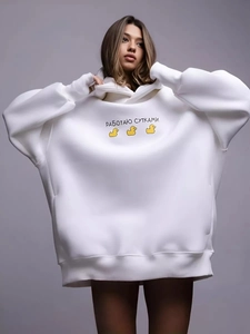 Oversized white hoodie with yellow duck prints and Russian text on a studio model