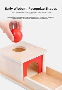 Close-up of hand placing a red wooden ball into the Montessori object permanence box