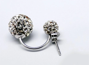 Macro shot of silver Shamballa stud earrings with double-sided white rhinestone spheres
