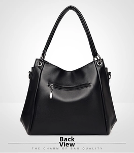 Detail view of the back pocket with metal zipper on this black lychee leather tote bag