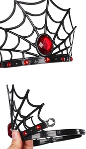 Close-up of gothic spider web tiara featuring red rhinestones and textured black finish