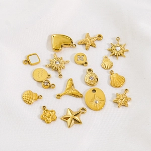 Variety of 14K gold-plated stainless steel charms including heart, starfish, and sun