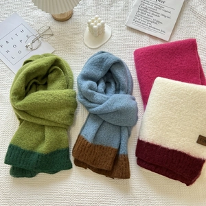 Detailed flat lay of soft cashmere-feel knitted scarves in various contrasting colors