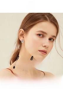 Close-up of elegant S925 silver six-prong moissanite hoop earring on model's ear