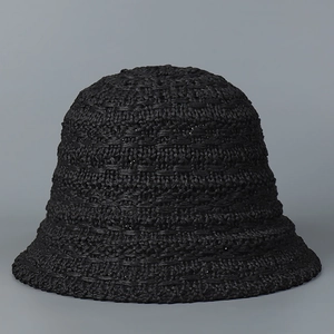 Detailed view of the intricate crochet texture on this black knit bucket sun hat for women