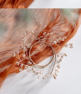 Detailed view of crystal beaded bridal headband with silver wire on white background
