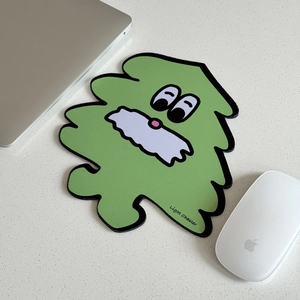 Detail of green monster shape mouse pad with anti-slip base on minimalist office desk