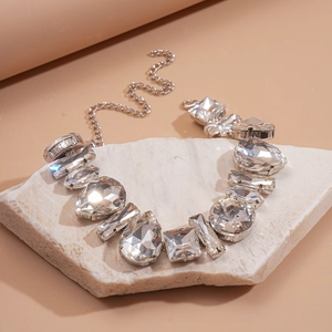 Detailed view of silver necklace with multi-shape clear crystals on stone base