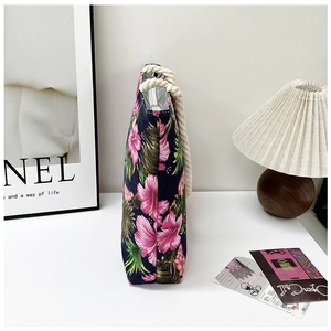 Detail view of tropical floral canvas tote with white cotton rope handles and zip closure