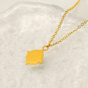 Detailed view of sunburst pendant necklace in 18K gold plated stainless steel