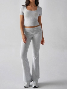 Detail of grey Y2K two-piece set featuring crop top and high waist flared pants