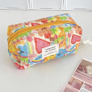 Quilted cartoon travel makeup bag with rainbow patterns and yellow zipper closure