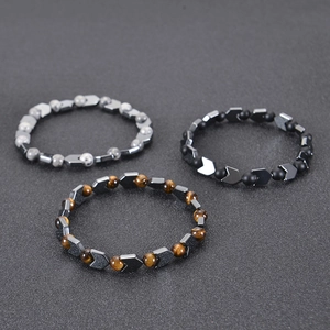 Close-up of three-piece beaded bracelet set featuring tiger eye and obsidian stones