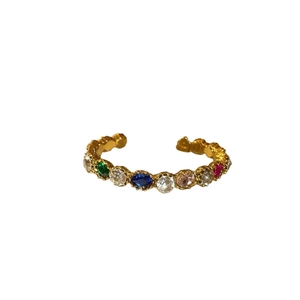 Vintage gold open ring featuring a row of colorful multi-gemstones in a rainbow design