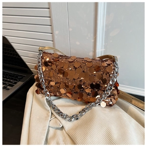 Detail of bronze sequins with silver chain handle on a stylish crossbody evening bag