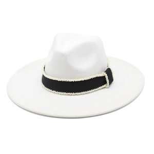 Detail of white wide brim fedora hat featuring black ribbon with white pearl embellishments