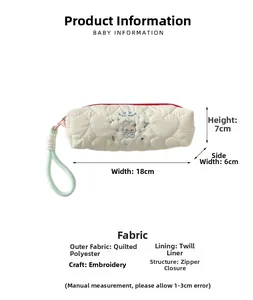 Detailed view of cream quilted pencil case featuring cute rabbit embroidery and red zipper