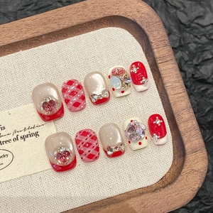 Pink and red bow plaid press-on nails with heart rhinestones and cat eye gems