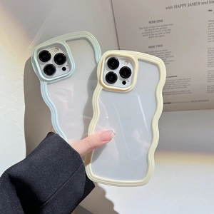 Wavy edge phone case in light green and beige shown on an English book background
