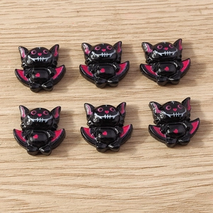 Detail of glossy resin cartoon bat charms for DIY crafts with pink heart accents