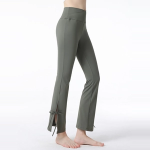 Cross high waist flared yoga pants with side slits and bow ties in grey-green hue