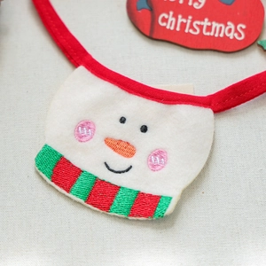 Detail of Christmas pet bandana with snowman embroidery and festive striped scarf design
