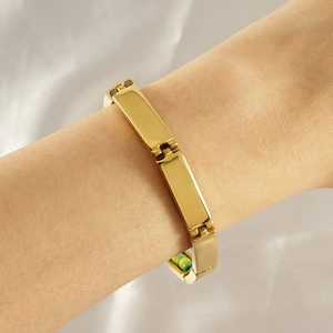 Detailed shot of a gold-plated titanium bead bracelet on a wrist with a modern design