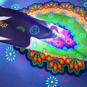 Close-up of mandala tapestry detail showing vibrant chakra symbols and fabric texture