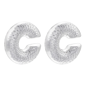 Macro detail of thick silver C-shape earrings featuring a hammered metal texture surface