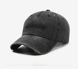 Detail of vintage washed baseball cap with red AVENUE embroidery and distressed holes