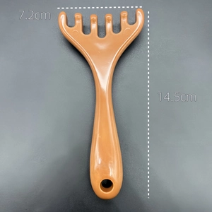 Macro detail of brown 5-tooth scalp massager with dimensions 7.2cm by 14.5cm