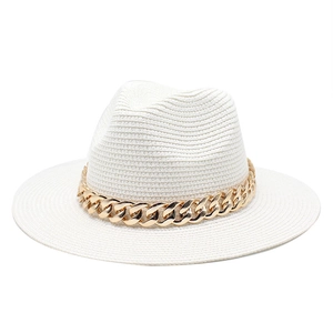 Close-up of white woven straw jazz hat featuring a chunky gold acrylic chain detail