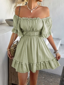 Close-up of light green off-shoulder mini dress with ruffle sleeves in resort style