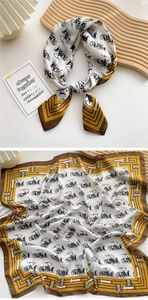 Detail of elegant silk square scarf with vintage carriage print and gold accents
