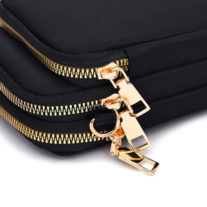 Minimalist black nylon crossbody phone bag with multi-layer gold zippers for women