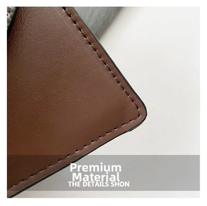 Macro detail of dark brown crocodile texture leather with neat reinforced stitching