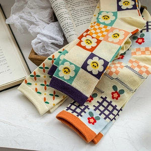 Japanese style colorful plaid cotton crew socks with floral patterns on a wooden tray