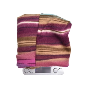 Detailed close-up showing a 46.2g lightweight striped knit hat on a digital scale