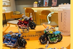 Detailed close-up of colorful alloy motorcycle model keychain with metal ring