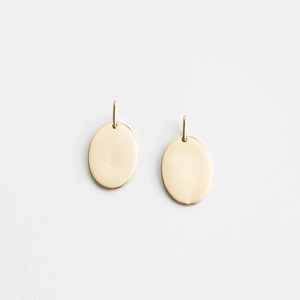 Polished gold-plated oval pendant charms with metal ring loops on white background